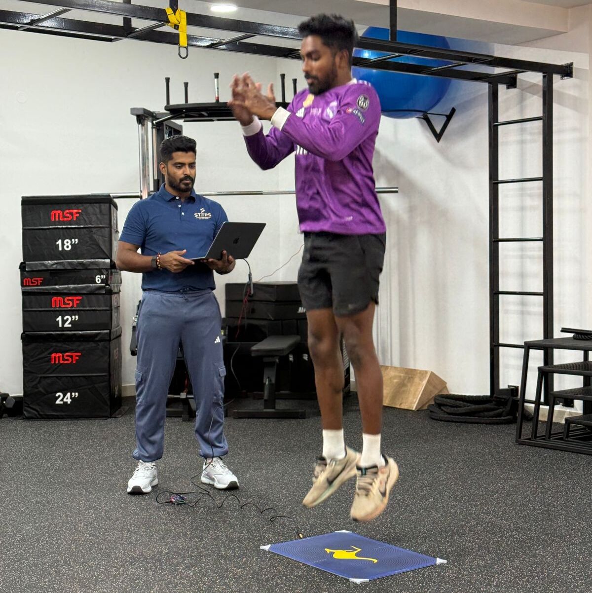 Coach assessing athlete for sport-specific skills